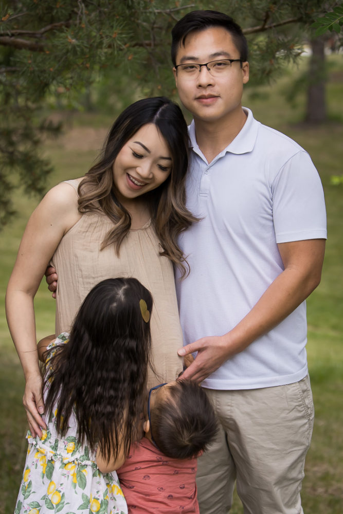 Outdoor family photos - kids crashing parent portrait by Paper Bunny Studios Edmonton