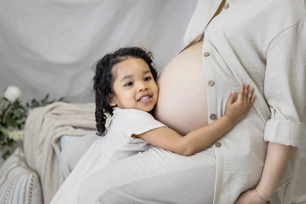 Edmonton studio maternity session of big sister cuddling bump by Paper Bunny Studios