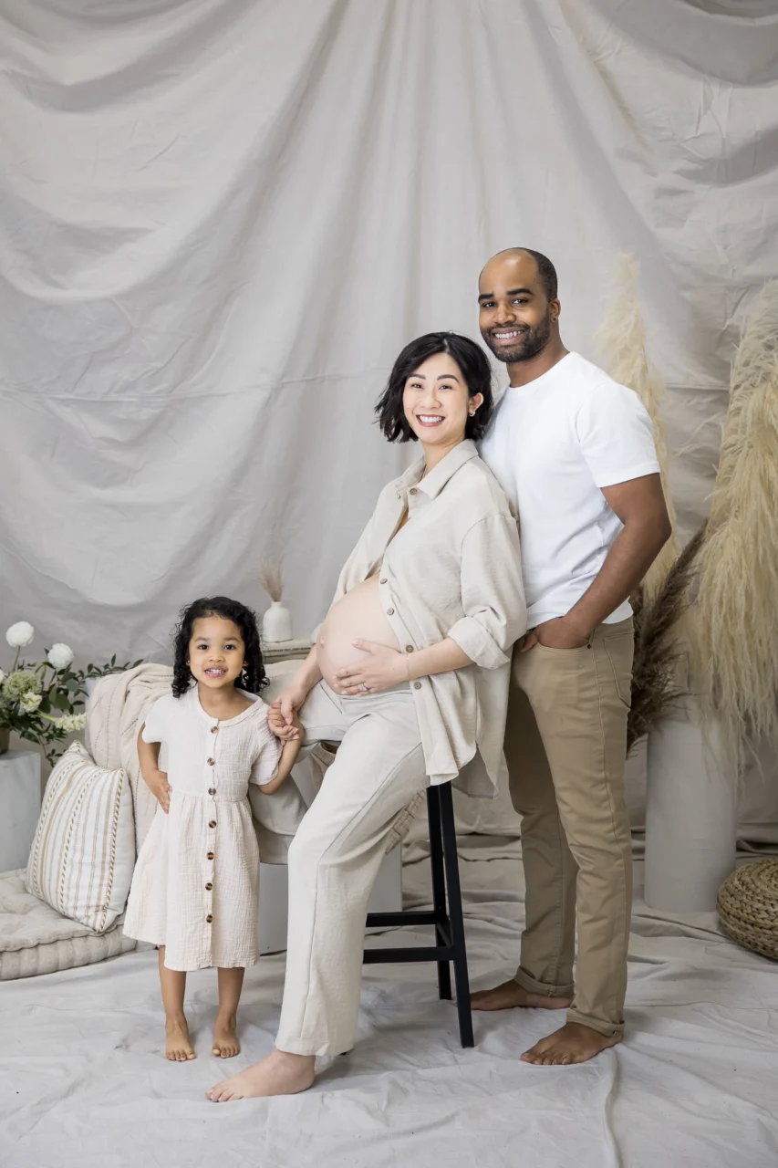 Edmonton studio maternity session of mom,dad & big sister in neutral clothing by Paper Bunny Studios