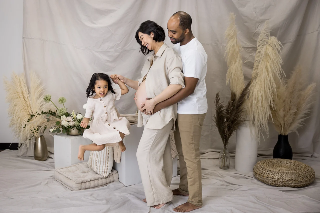 Edmonton maternity photo session of mom, dad & big sister in a studio by Paper Bunny Studios