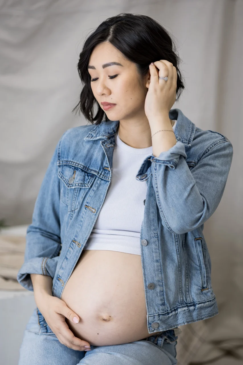 Maternity portrait of mom cradling bump by Edmonton family photographer Paper Bunny Studios