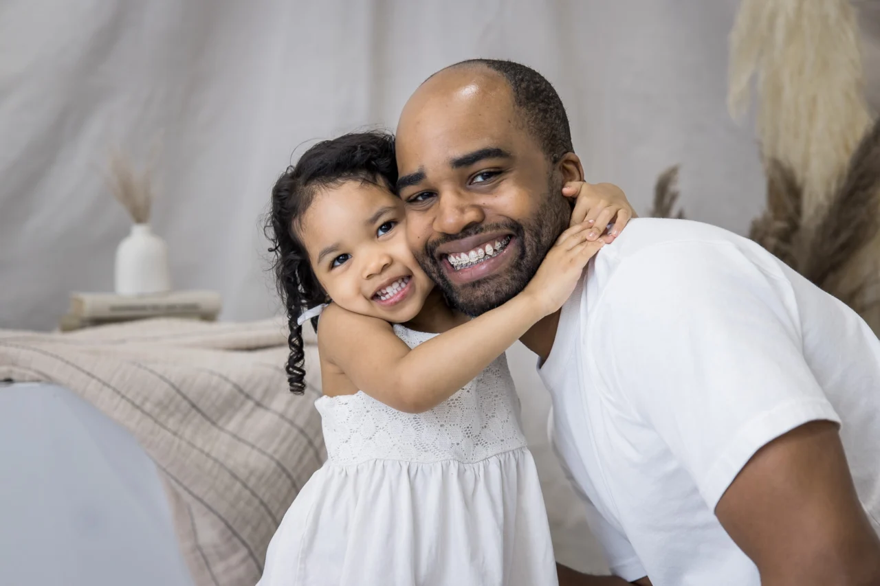 Cute portrait of daughter hugging dad by Edmonton family photographer Paper Bunny Studios