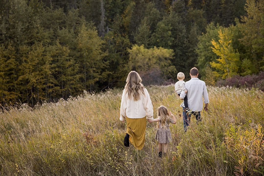 Outdoor documentary Fall family photo of family walking in a field in Edmonton by Paper Bunny Studios