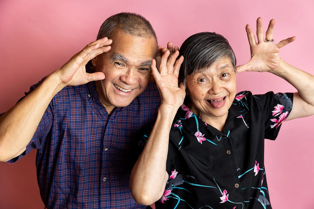 Older adults colourful portrait session showing grandparents pulling a silly face by Paper Bunny Studios Edmonton family photographer