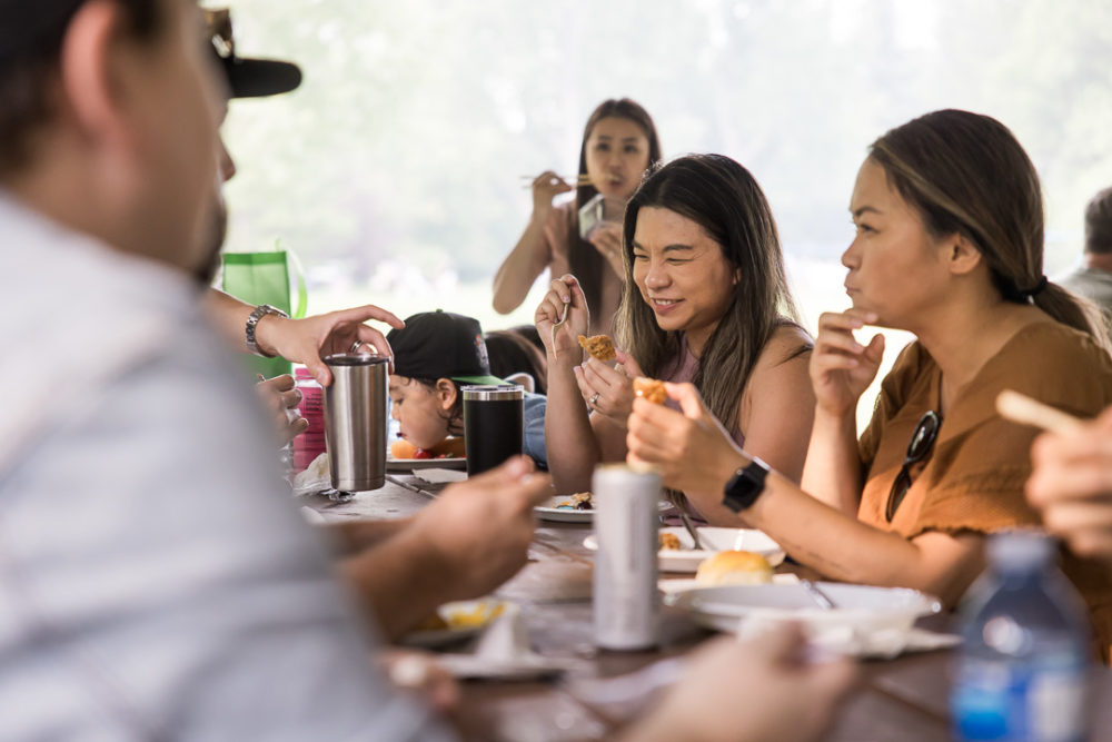 Documentary family reunion photography of grown ups eating by Paper Bunny Studios Edmonton