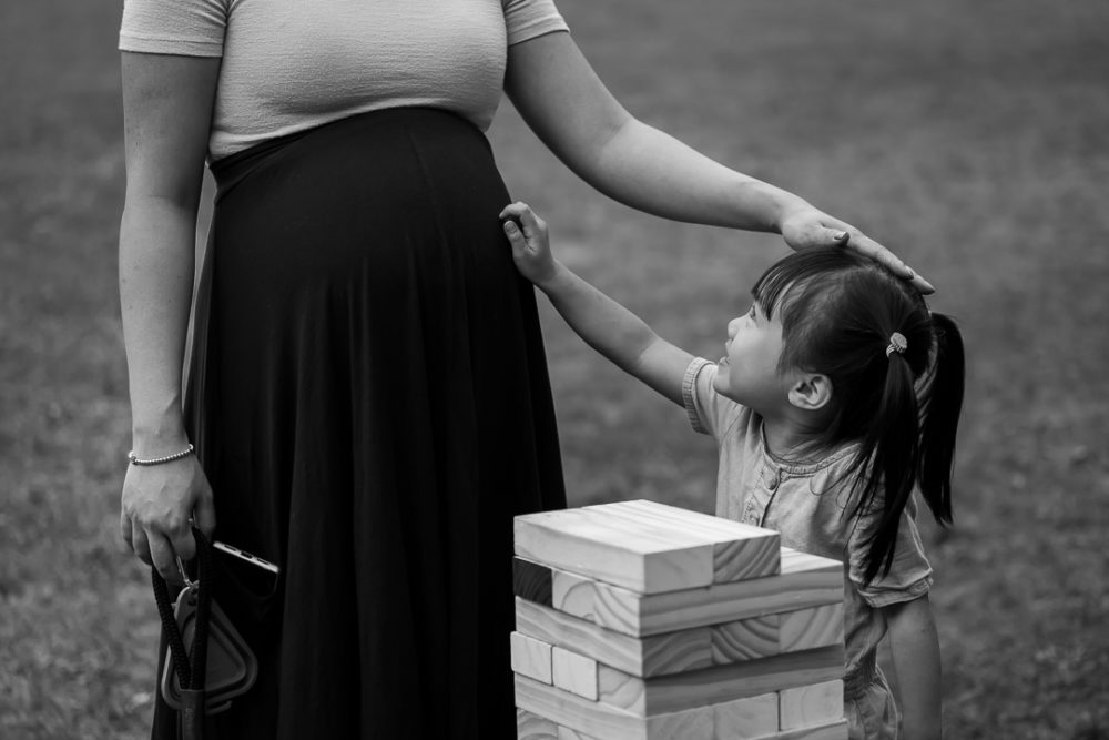 Documentary family reunion photography of touching moment between mom & daughter by Paper Bunny Studios Edmonton