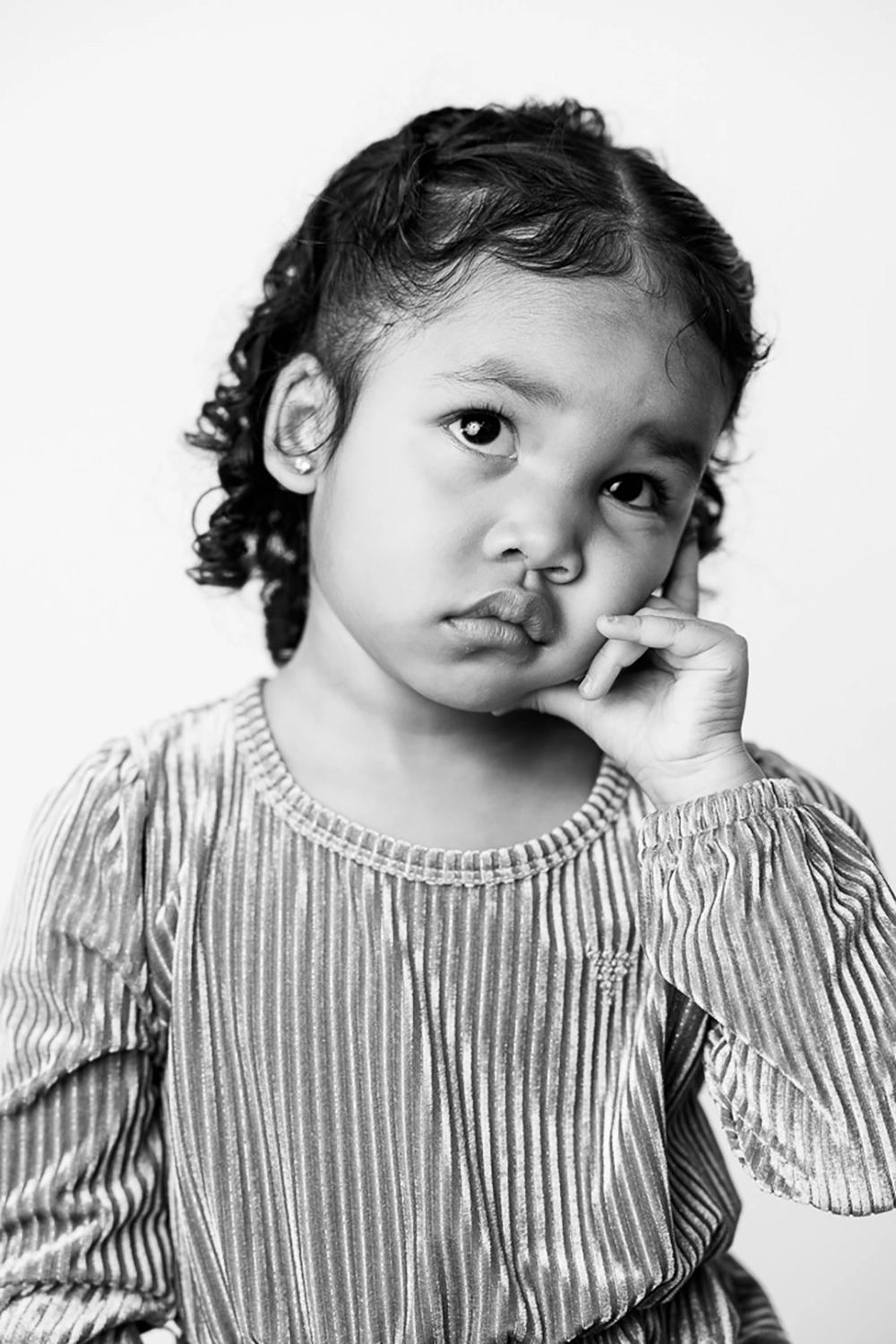 Black & white portrait of little girl looking thoughtful by Edmonton family photographer Paper Bunny Studios