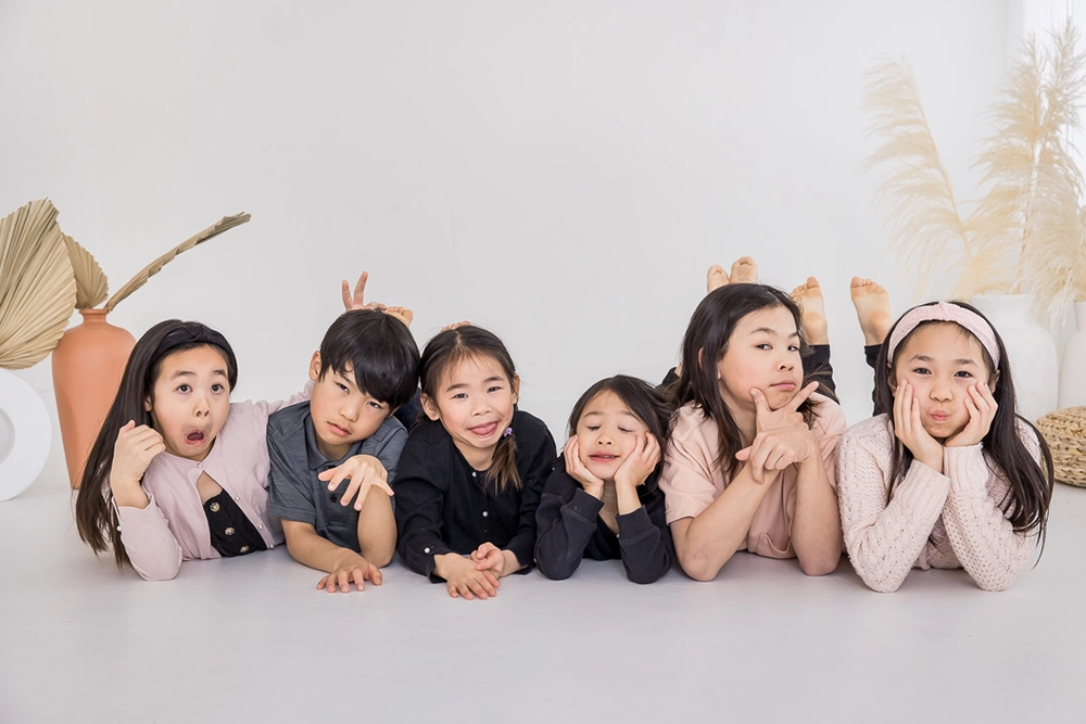 Cousins photo with silly expressions  by Edmonton Family Photographer Paper Bunny Studios