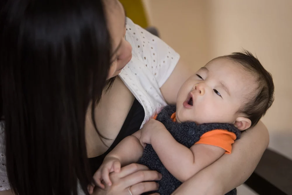 Calgary documentary newborn photo shoot of baby boy yawning by Paper Bunny Studios