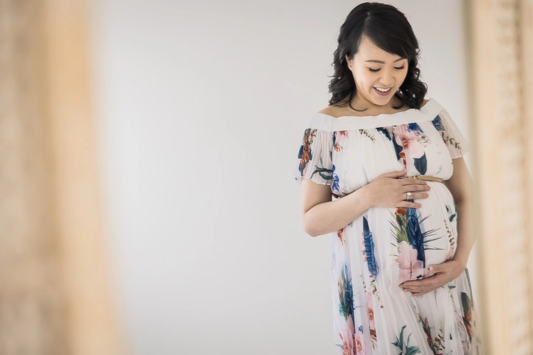 Maternity photos mom cradling bump reflected in mirror by Paper Bunny Studios Edmonton family photographer