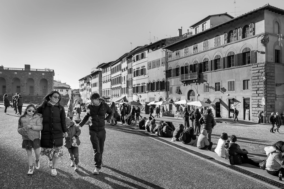 Black & white photo of family walking in Florence by Edmonton family photographer Paper Bunny Studios