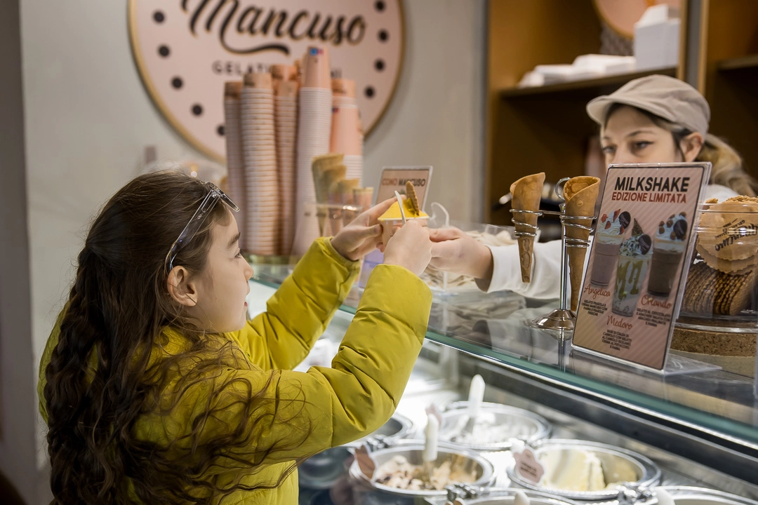 Young girl getting gelato in Florence by Edmonton family photographer Paper Bunny Studios