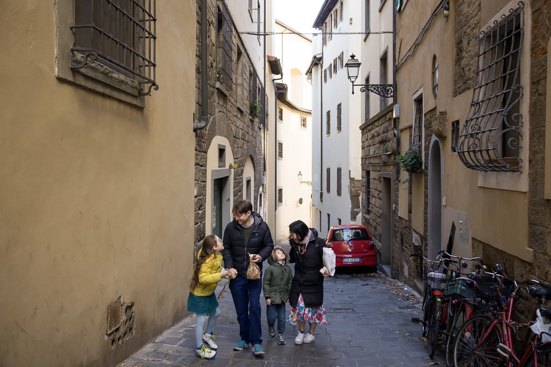 Family walking along in Florence by Edmonton documentary family photographer Paper Bunny Studios