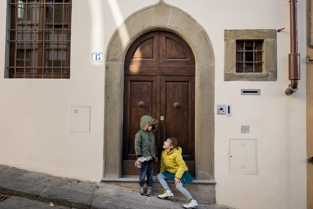 Brother & Sister by a doorway in in Florence by Edmonton family photographer Paper Bunny Studios