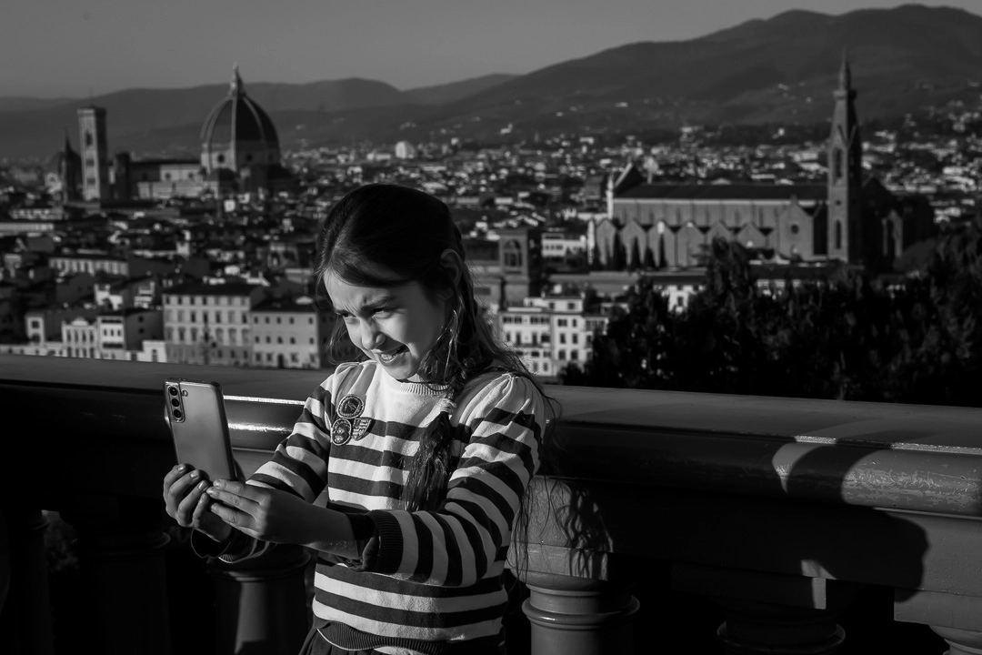 Young girl taking a selfie in Florence by Edmonton family photographer Paper Bunny Studios