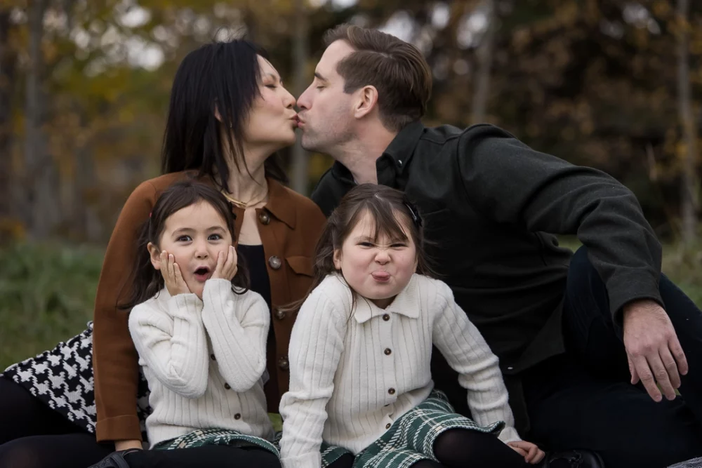 Girls expression after seeing mom & dad kiss by Edmonton Documentary family photographer Paper Bunny Studios
