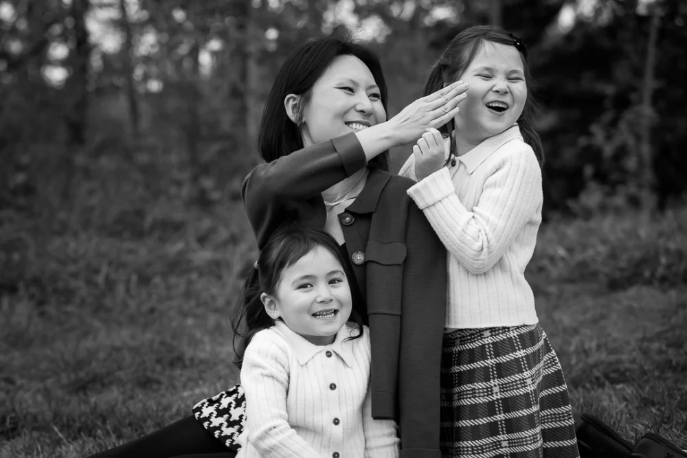 Mom wiping something off daughter's cheek by Edmonton Documentary family photographer Paper Bunny Studios