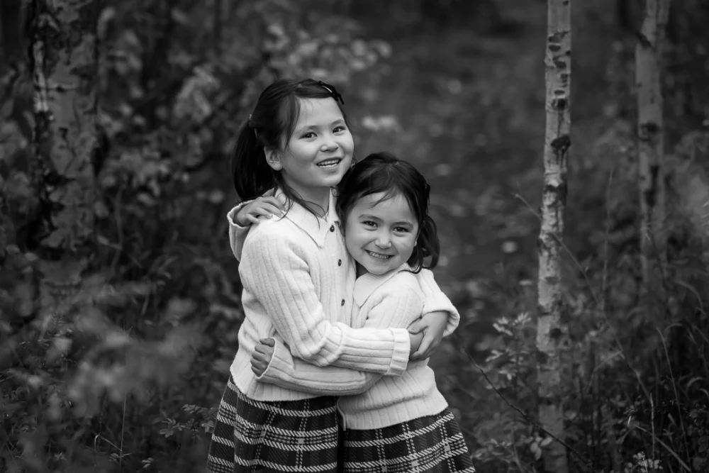 Outdoor family portrait of young girls by Edmonton Documentary family photographer Paper Bunny Studios