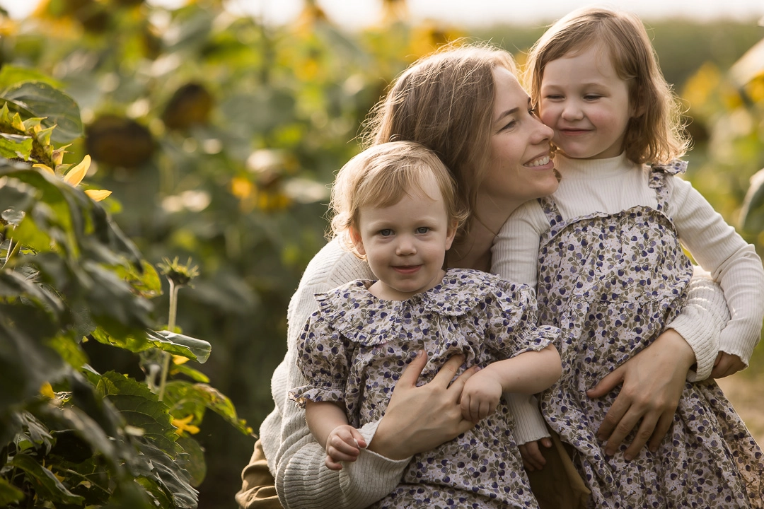 Edmonton family photos in sunflower field with  mom & daughters by fine art family photographer Paper Bunny Studios