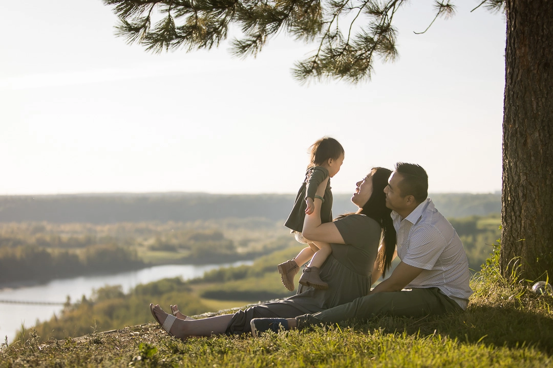 Outdoor family photos of Mom lifting up toddler by the River Valley by Edmonton family photographer Paper Bunny Studios