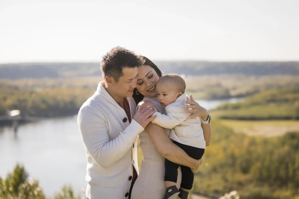 Outdoor family photo of parents with baby by Paper Bunny Studios Edmonton